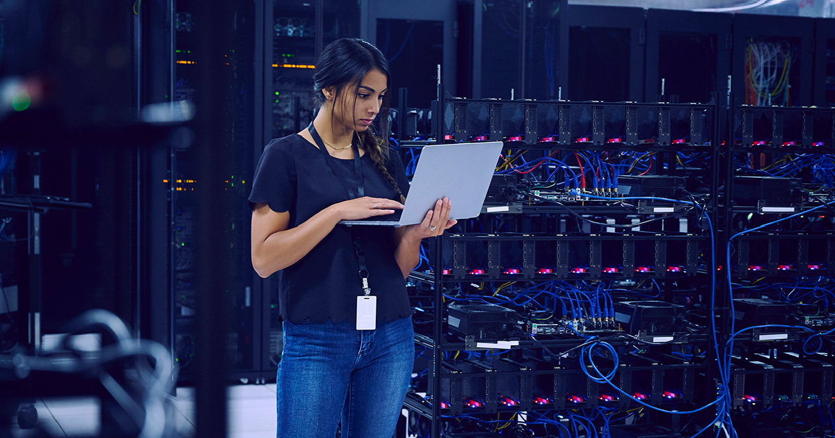 woman_looking_servers woman looking at computer in server room