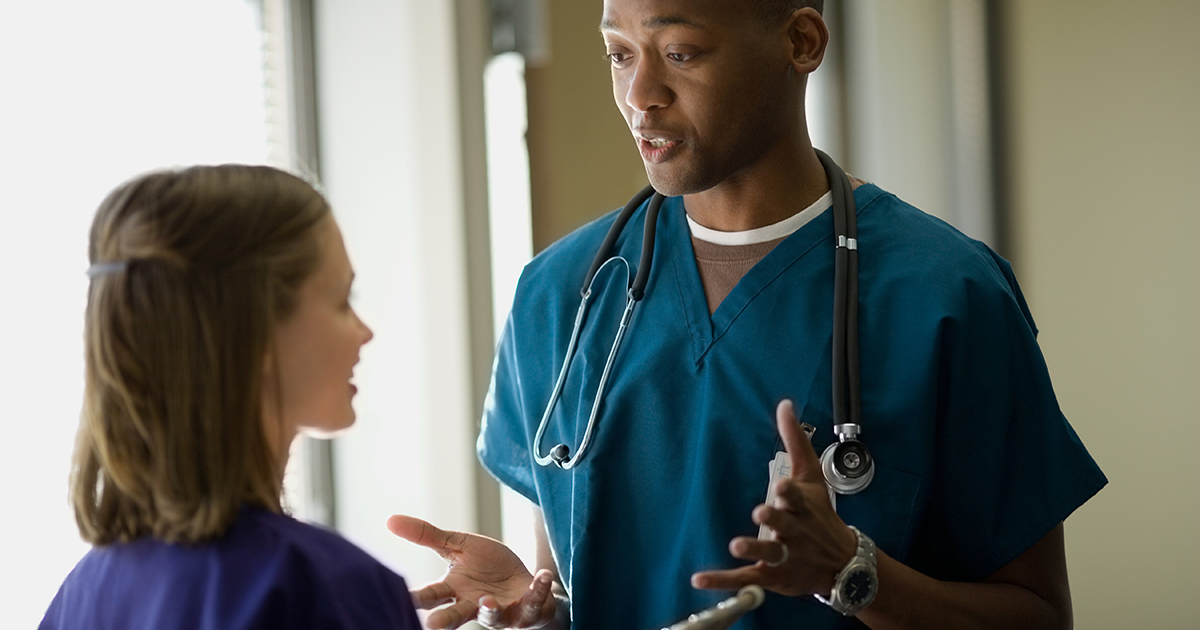 male nurse talking to student